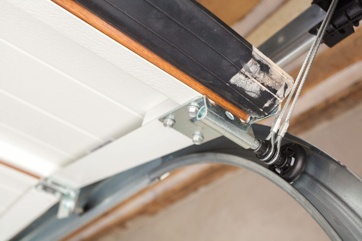 Garage door springs and cables being serviced